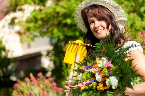 Landscaper inspecting a garden area for reported issues